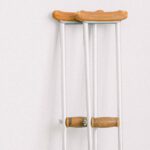 Chronic Illness Support - Crutches against light white wall