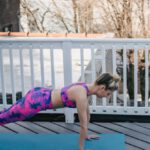 Core Strength - Slim female doing plank exercise during training outside