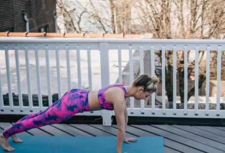 Core Strength - Slim female doing plank exercise during training outside