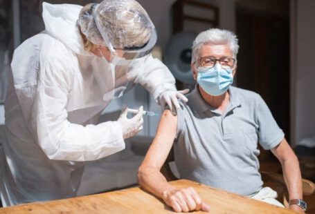 Adult Vaccination - Elderly Man in Gray Polo Shirt with Face Mask Having Vaccination