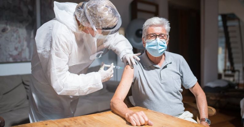 Adult Vaccination - Elderly Man in Gray Polo Shirt with Face Mask Having Vaccination