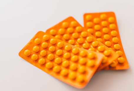 Headache Remedy - Orange packages of medications on table