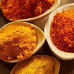 Turmeric - Four Assorted Spices On Wooden Spoons