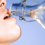 Drinking Water - Woman Drinking Water From Glass Bottle